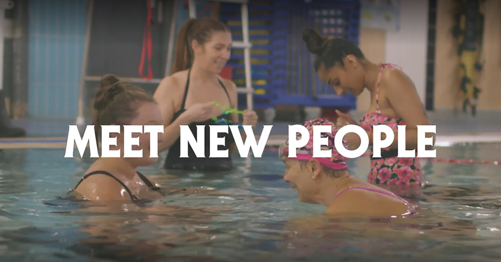 Women in a swimming pool, talking at the side of the pool, with an overlay saying 'meet new people'