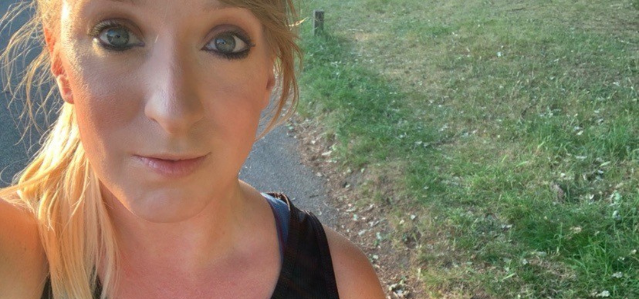 Rebecca taking a selfie outside with the grass behind her. 