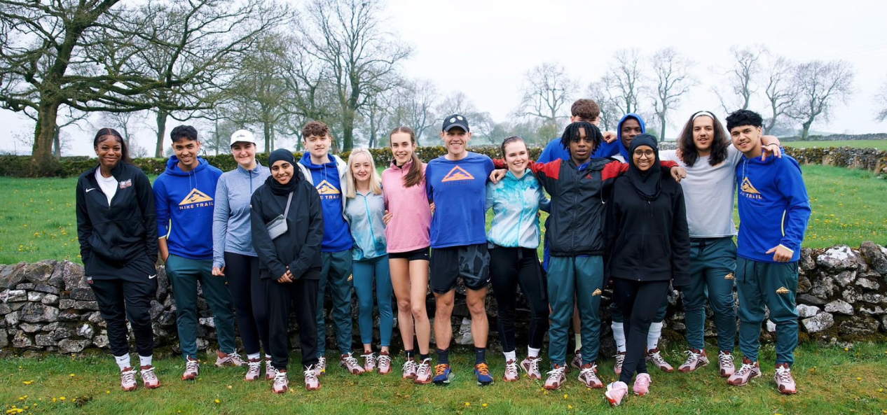 Lily and her friends outside stood together and smiling. 