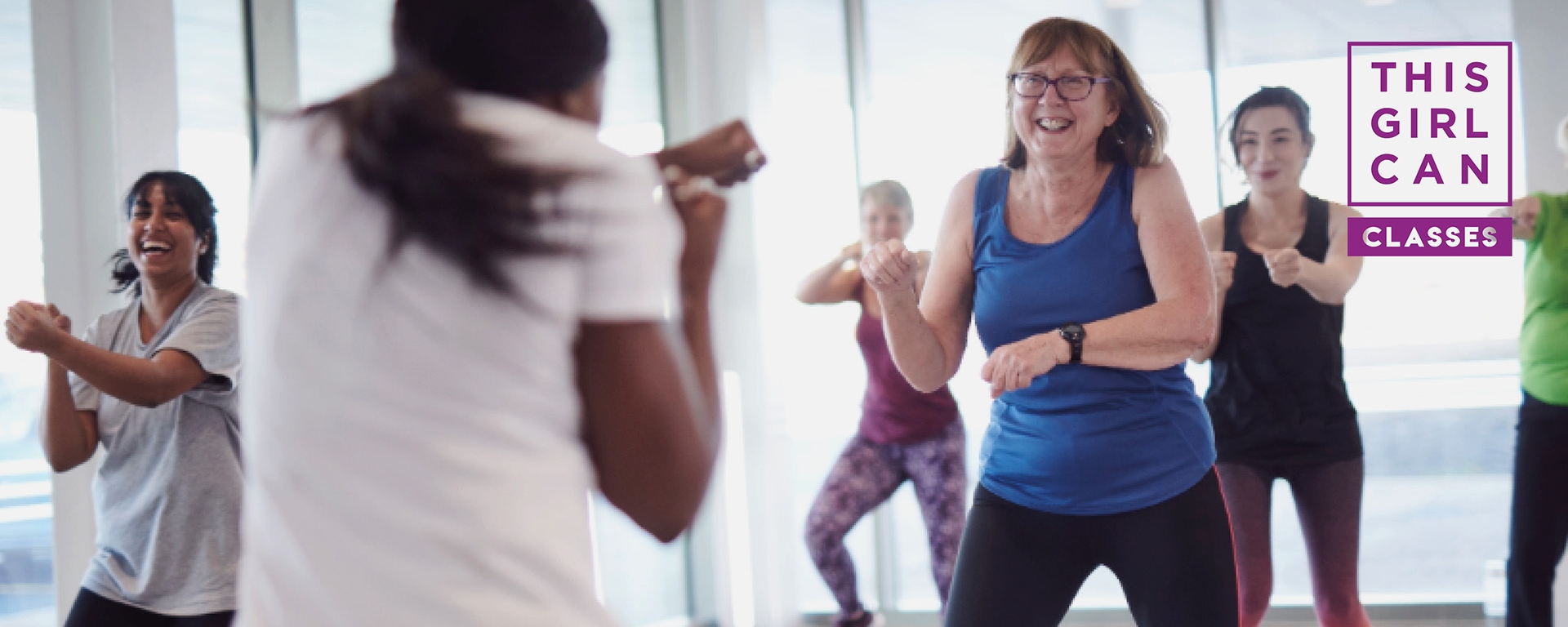 A group of women take part in an exercise class