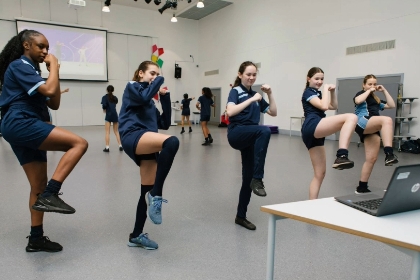 Teenage girls enjoying Studio You class at school