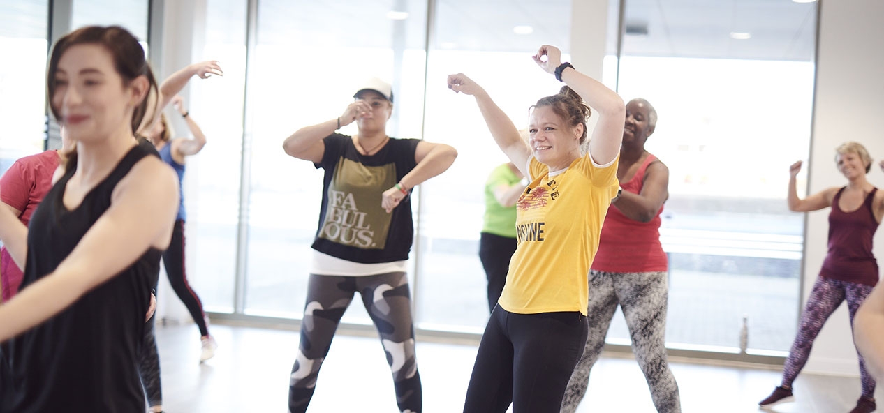 A group of women dance in an exercise class