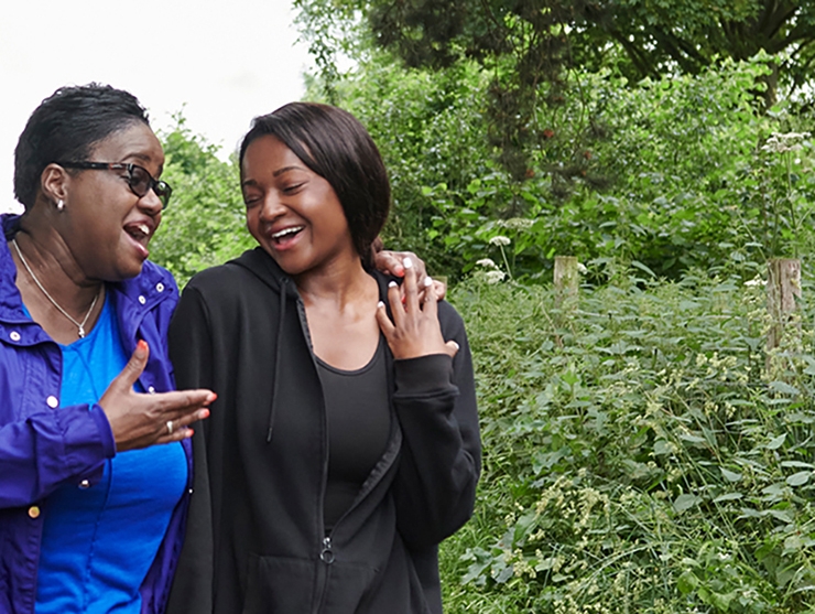 Two women walk  along a path