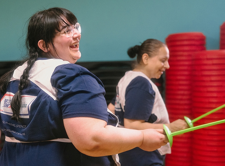 Women fence with plastic swords