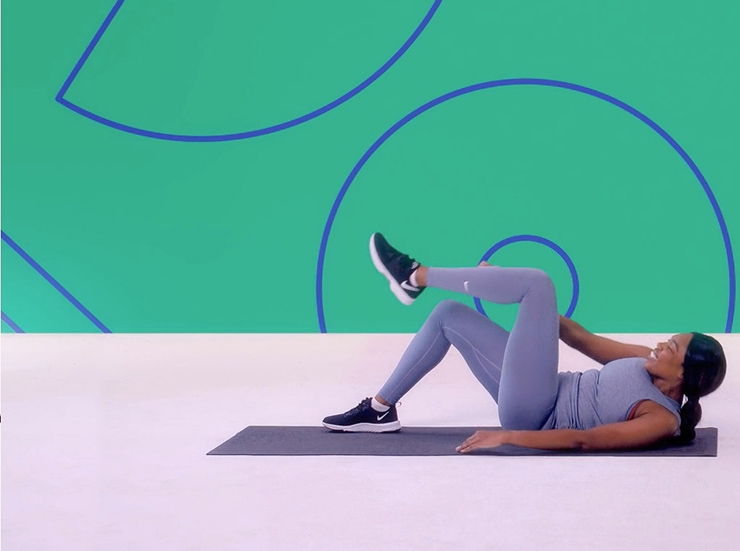 A woman does crunches in a Studio You video