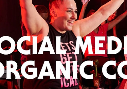 The cover of the organic content document - a woman with her arms in the air at a spin class