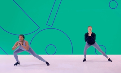 Two girls perform side lunges in an exercise class as part of a Studio You video