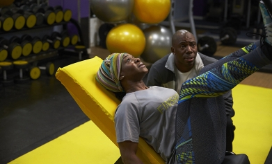 A woman uses a leg press machine in a gym